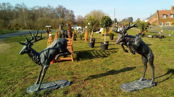 Two leaping deer statues outdoor showcase