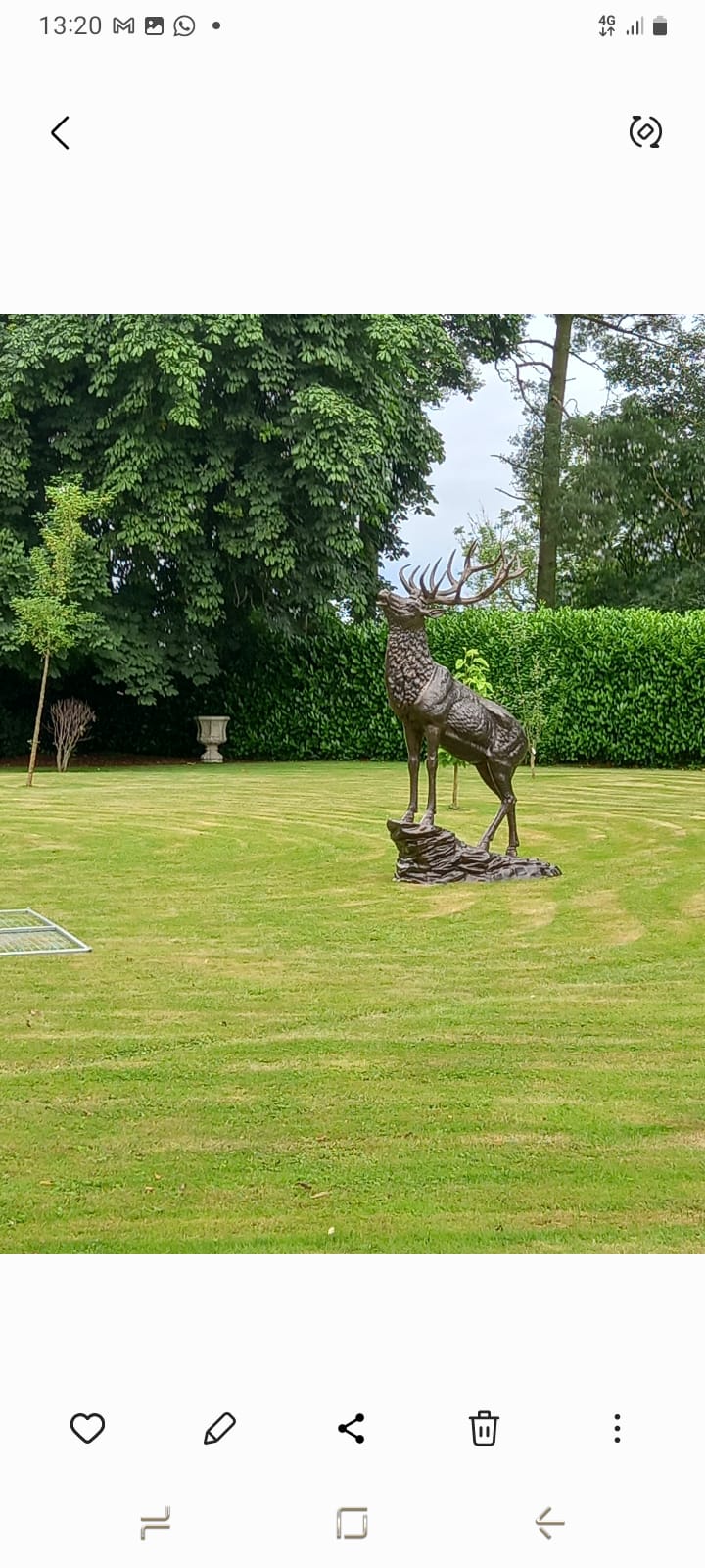 Large stag statue on lawn setting