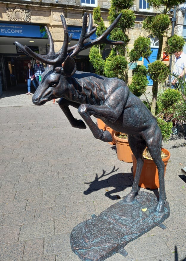 Large deer statue in urban setting